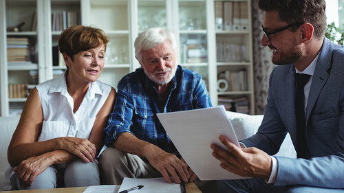 Senior couple planning their investments with financial advisor