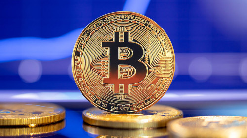 Gold Bitcoin crypto currency on background of chart diagram