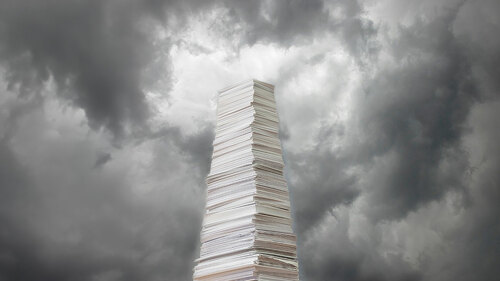 Stack of paper against a stormy sky