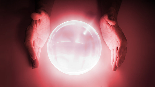 Magician or fortune teller is predicting future with crystal sph