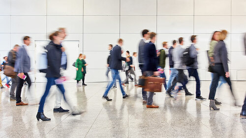 Anonymous crowd of people goes in trade fair or airport