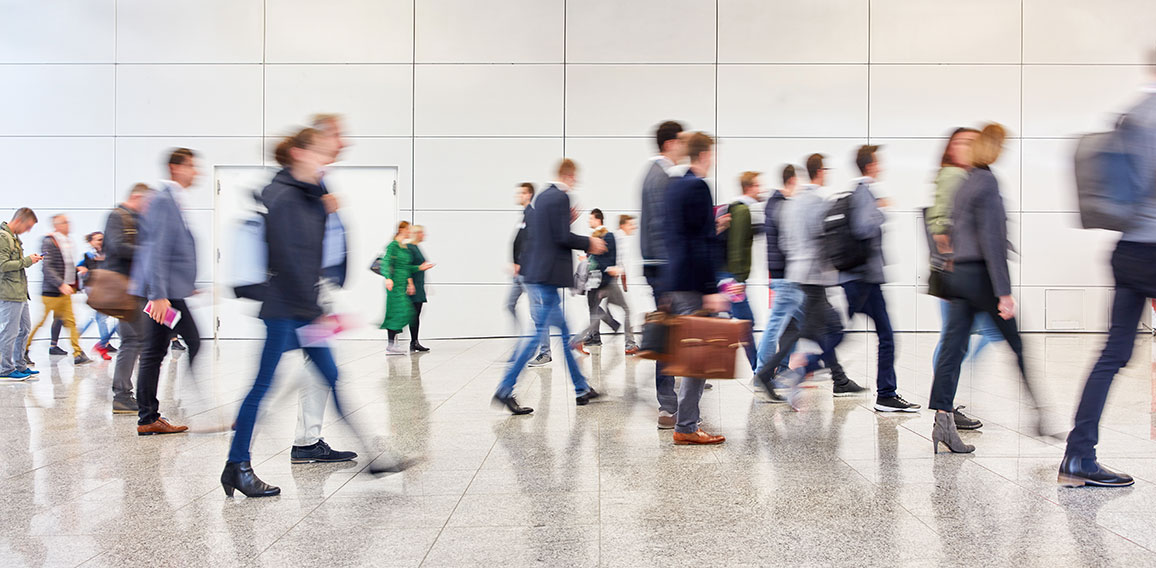 Anonymous crowd of people goes in trade fair or airport