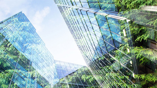 green city - double exposure of lush green forest and modern sky