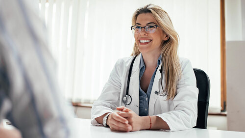 Smiling female doctor with a patient in the office.