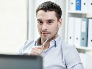 young businessman with laptop computer at office