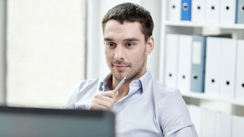 young businessman with laptop computer at office