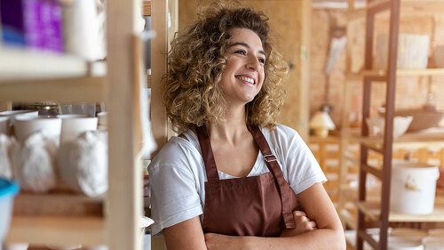 Portrait of woman pottery artist in art studio