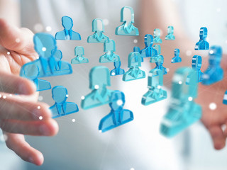 Businessman holding 3D rendering group of blue people