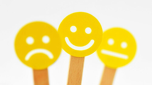 Yellow smiley faces with positive, neutral and negative expressi