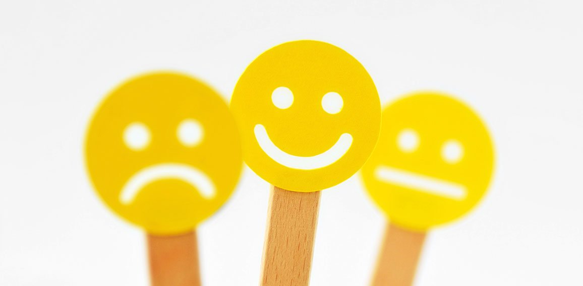 Yellow smiley faces with positive, neutral and negative expressi