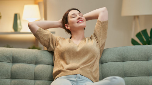 woman resting on sofa