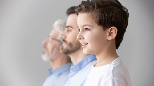 Child boy grandson stand in row with father and grandfather