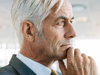Senior entrepreneur looking pensive in office