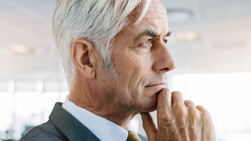 Senior entrepreneur looking pensive in office