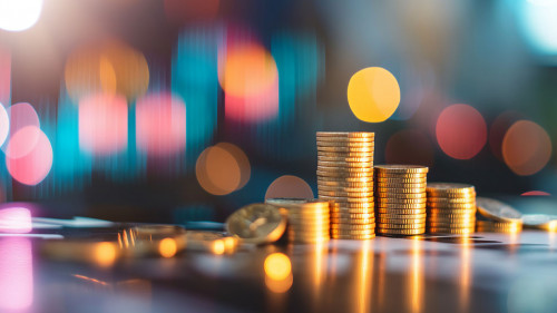 Stacks of coins with a blurred colorful bokeh light background,