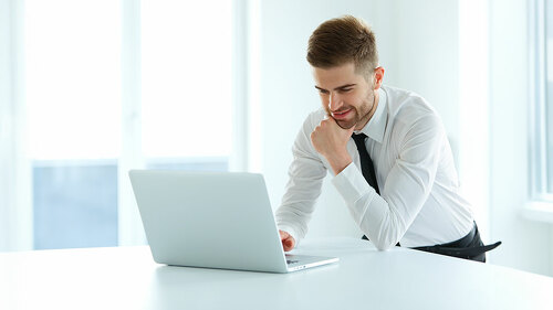 Handsome Businessman Working on Laptop at His Office