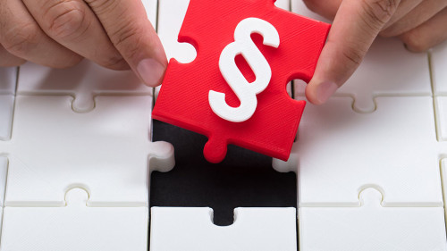 Person connecting last red piece into jigsaw puzzles