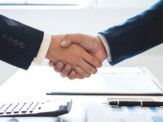 Finishing up a meeting, handshake of two happy business people a