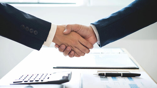 Finishing up a meeting, handshake of two happy business people a