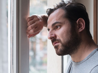 Man suffering and feeling alone at home