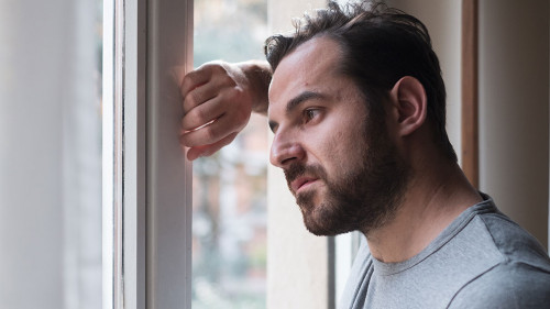 Man suffering and feeling alone at home