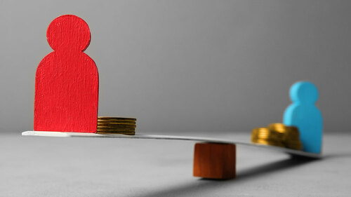 Inequality people income gap. Gold coins on scales.