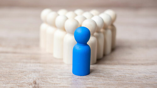 blue leader businessman with crowd of wooden men. leadership, bu