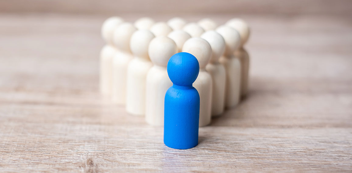 blue leader businessman with crowd of wooden men. leadership, bu