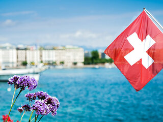 Flag of Switzerland over the lake in Geneva