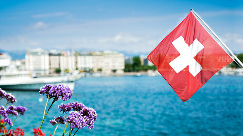 Flag of Switzerland over the lake in Geneva