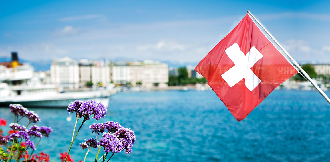 Flag of Switzerland over the lake in Geneva