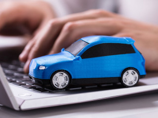 Blue Car On Laptop Keypad