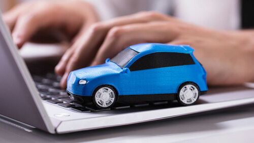 Blue Car On Laptop Keypad