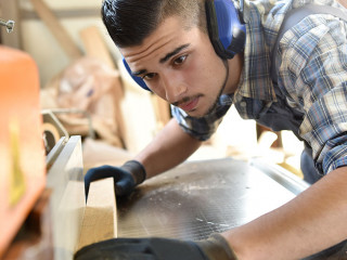 Young man in woodwork training course