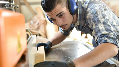 Young man in woodwork training course