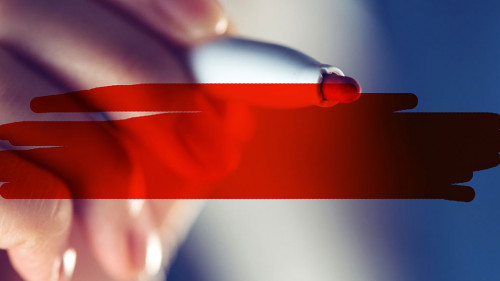 Red marker in female hand, highlighted area as copy space