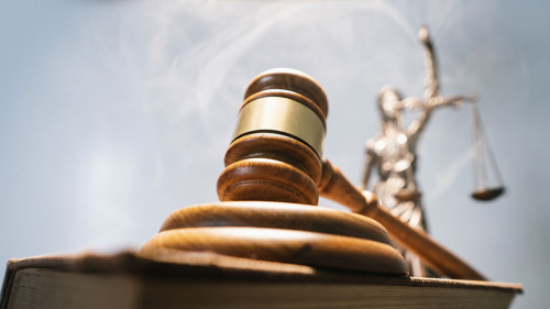 Statue of lady justice on bright background - Side view with cop