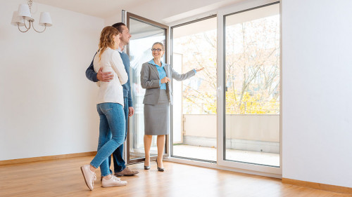 Young couple getting tour through apartment they consider renting