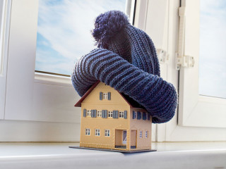 house in winter - heating system concept and cold snowy weather with model of a house