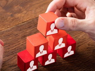 Block Of Team On Wooden Desk
