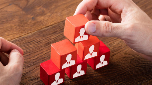 Block Of Team On Wooden Desk