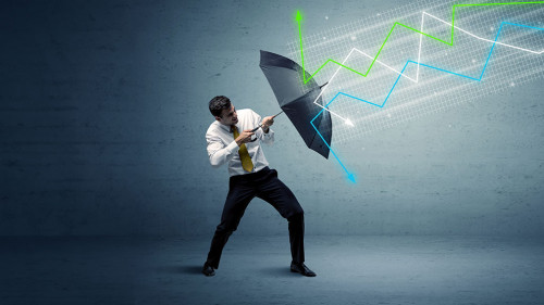 Business person with umbrella and stock market arrows concept