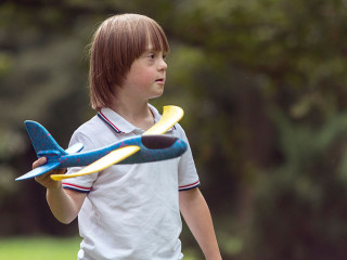Mentally Challenged Boy Launching a Toy Airplane