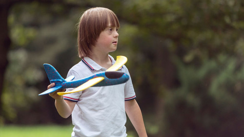 Mentally Challenged Boy Launching a Toy Airplane