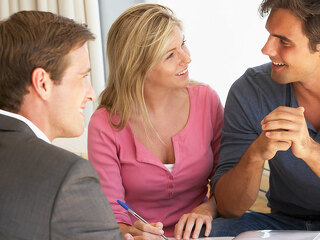 Couple Meeting With Financial Advisor At Home