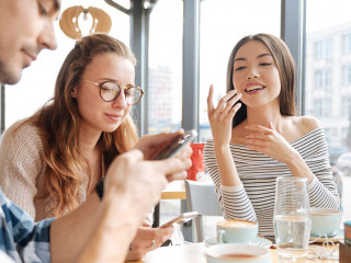 Friends using smartphones in the cafe