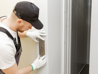 Lift machinist man repairing elevator fixing or adjusting mechanism