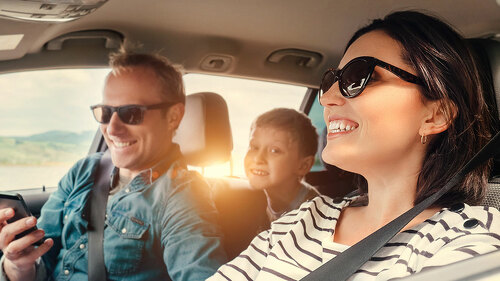 Happy family riding in a car