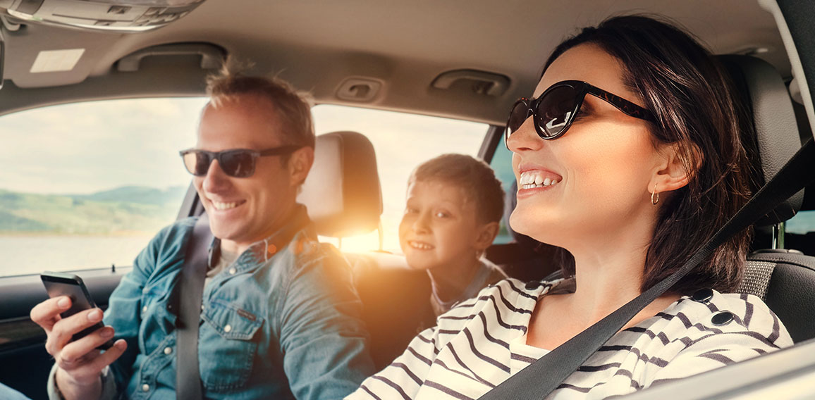 Happy family riding in a car