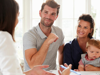 Family With Baby Meeting Financial Advisor At Home
